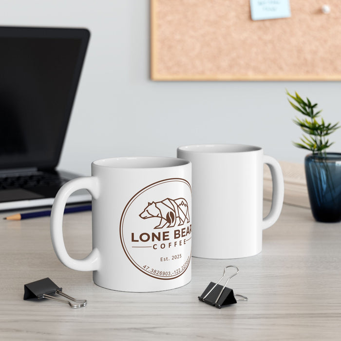 Two white mugs with a bear logo and 'Lone Bear Coffee' text on a desk with office supplies.