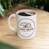 White mug with 'Lone Bear Coffee' logo on a wooden table
