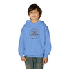 Young boy smiling, wearing a blue Lone Bear Cub Hoodie with the brand's circular bear logo visible on the chest.