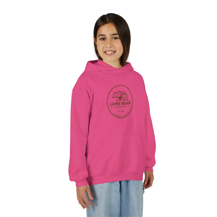 Young girl smiling, wearing a pink Lone Bear Cub Hoodie with the brand's circular bear logo visible on the chest.