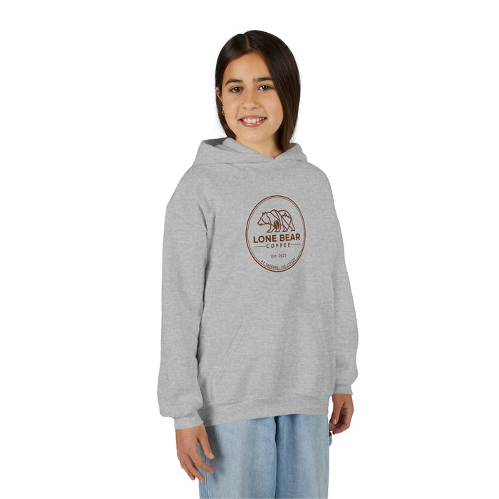 Young girl smiling, wearing a grey Lone Bear Cub Hoodie with the brand's circular bear logo visible on the chest.