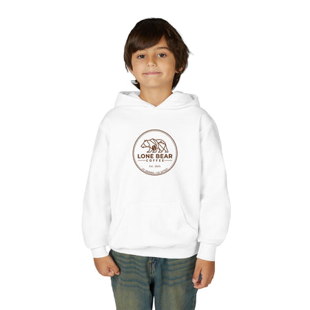 Young boy smiling, wearing a white Lone Bear Cub Hoodie with the brand's circular bear logo visible on the chest.