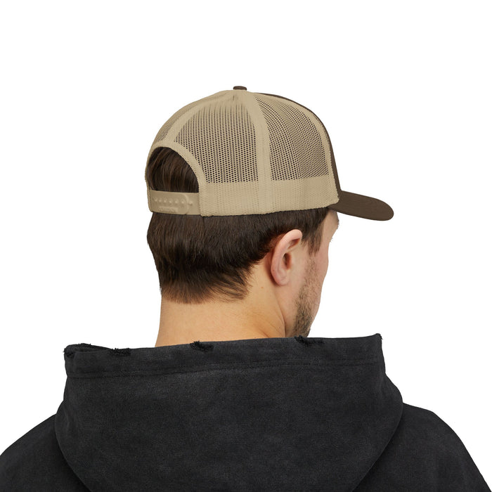 Person wearing a black hoodie and a brown and beige cap on a white background